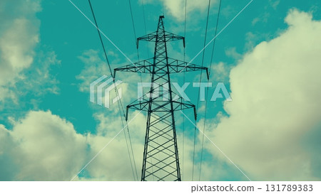 A Power Transmission Tower stands against a dramatic, cloudy sky, showcasing modern infrastructure A Power Transmission Tower stands against a dramatic, cloudy sky, showcasing modern infrastructure 131789383
