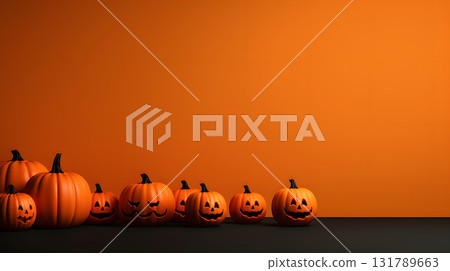 Pumpkins with carved faces lined up against an orange background for Halloween decoration 131789663