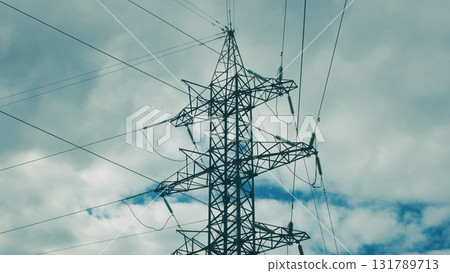 High Voltage Power Transmission Tower Standing Majestically Against a Dramatic Sky 131789713