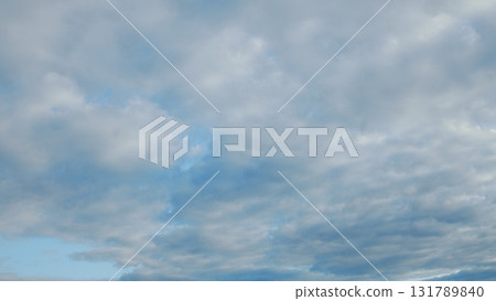 A stunning cloudscape accompanied by a soothing touch of bright blue skies above A stunning cloudscape accompanied by a soothing touch of bright blue skies above 131789840