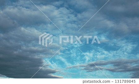 A Beautiful Cloudy Sky Displaying Stunning Shades of Blue and Various Textures Above 131789845