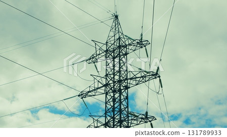 A High Voltage Power Transmission Tower Standing Tall Under a Dramatic Cloudy Sky Above A High Voltage Power Transmission Tower Standing Tall Under a Dramatic Cloudy Sky Above 131789933