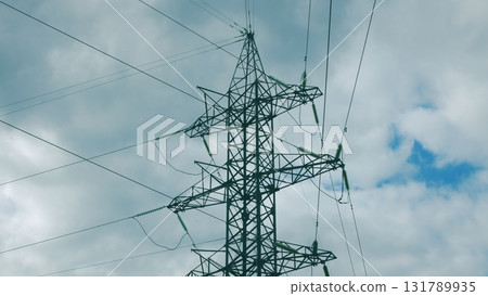 Electric Power Lines Stretching Under a Dramatic Cloudy Sky, Representing Modern Infrastructure 131789935