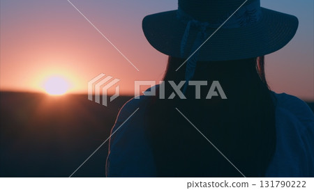 Enjoying a Serene Sunset View while Wearing a Stylish Hat A Perfect Moment for Deep Reflection Enjoying a Serene Sunset View while Wearing a Stylish Hat A Perfect Moment for Deep Reflection 131790222