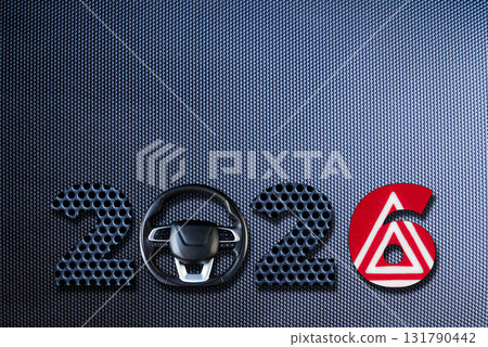 Modern 2026 text made of dark carbon fiber texture with car symbols and metallic design. 131790442