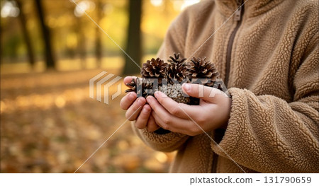 Child with pine cones Child with pine cones 131790659