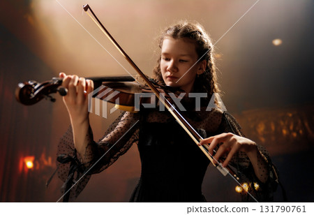 girl playing violin on stage girl playing violin on stage 131790761