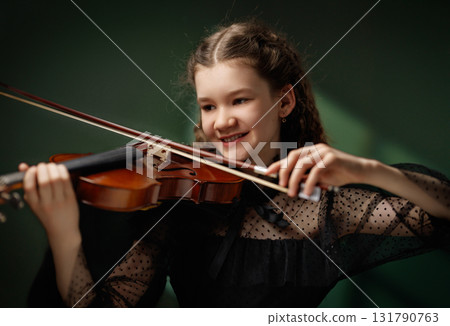 Young girl playing violin Young girl playing violin 131790763