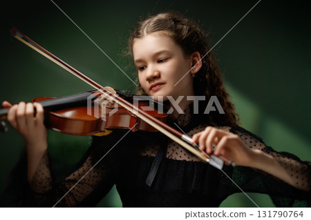 Young girl playing violin Young girl playing violin 131790764