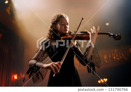 girl playing violin on stage 131790766
