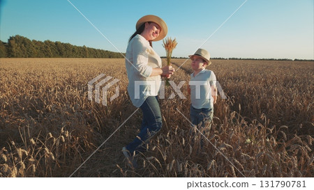A loving Mother and her Child are Joyfully Enjoying the Beauty of Nature in a Vibrant Field A loving Mother and her Child are Joyfully Enjoying the Beauty of Nature in a Vibrant Field 131790781