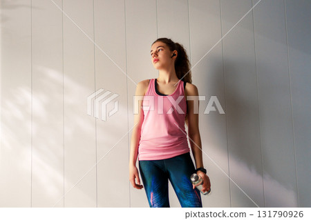 Woman in fashionable sportswear is doing exercise. 131790926