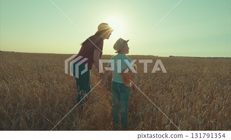 A Heartwarming Scene of a Mother and Her Child Having a Wonderful Day in the Wheat Field A Heartwarming Scene of a Mother and Her Child Having a Wonderful Day in the Wheat Field 131791354