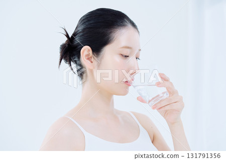 Young woman drinking water 131791356