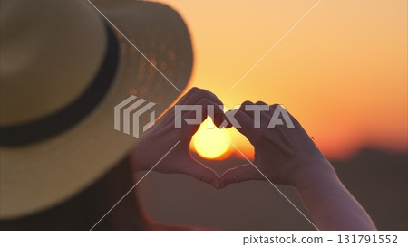 A beautiful sunset heart gesture is painted against a vibrant horizon that inspires awe and love A beautiful sunset heart gesture is painted against a vibrant horizon that inspires awe and love 131791552