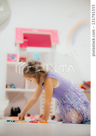 A Playful Child Dressed in a Colorful Outfit Engaged in a Creative and Joyful Activity 131791555