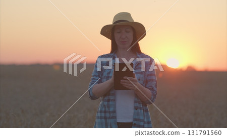 A Rural Farmer Utilizing a Tablet Device During the Beautiful Sunset in the Field A Rural Farmer Utilizing a Tablet Device During the Beautiful Sunset in the Field 131791560