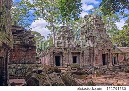 Ta Prohm temple ruins surrounded by forest Cambodia 131791580
