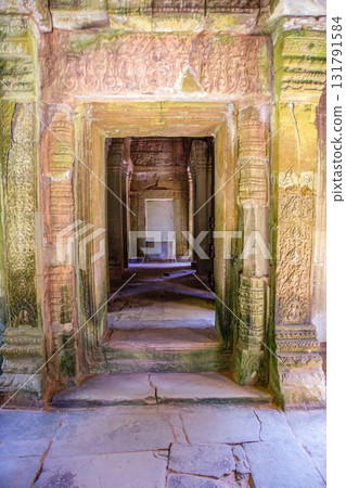 Stone corridor with carvings inside Angkor temple Cambodia Stone corridor with carvings inside Angkor temple Cambodia 131791584