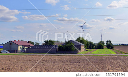 Windmills standing next to buildings. Windmills standing next to buildings. 131791594