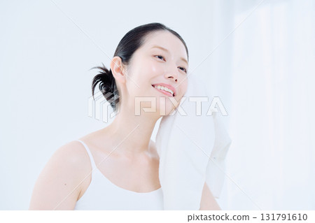 Washing face image of a young woman 131791610