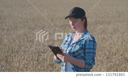 A Young Woman Engaged in Analyzing Data Collected from a Field Survey on Agriculture A Young Woman Engaged in Analyzing Data Collected from a Field Survey on Agriculture 131791801