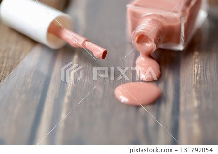 Beige-pink nail polish spilled from a container Beige-pink nail polish spilled from a container 131792054