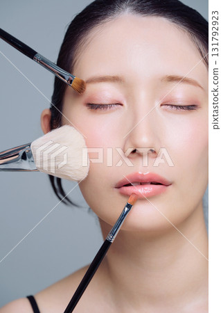 Close-up of a woman applying makeup Close-up of a woman applying makeup 131792923