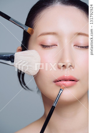 Close-up of a woman applying makeup Close-up of a woman applying makeup 131792924