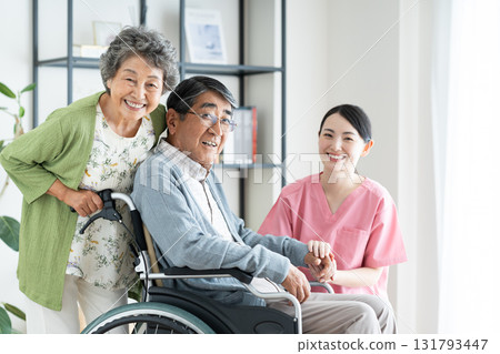 Senior couple in wheelchairs and caregivers 131793447