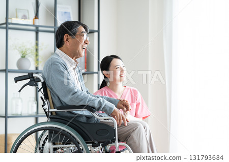 Senior man in wheelchair and care worker 131793684