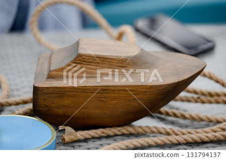 A wooden model of a boat or ship with a thick rope A wooden model of a boat or ship with a thick rope 131794137