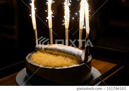 A round cake styled like a tin can of caviar and fish 131794181