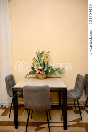 A dining table with four gray chairs 131794439