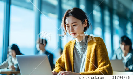 A young woman working in a stylish coworking space 131794736
