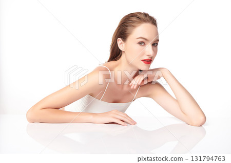 A beautiful young woman with clean, fresh skin against a white background. Skincare, facial treatment, cosmetology, beauty, and spa. An elegant portrait of an woman. A beautiful young woman with clean, fresh skin against a white background. Skincare, facial treatment, cosmetology, beauty, and spa. An elegant portrait of an woman. 131794763