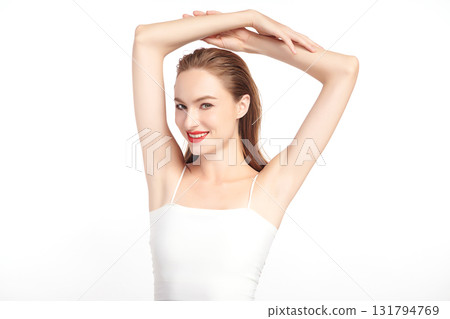 Beautiful Young woman Raises her hands to Showcase clean and hygienic underarms Against a white background, Smooth armpit cleanliness and protection concept 131794769