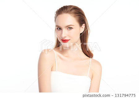 A beautiful young woman with clean, fresh skin against a white background. Skincare, facial treatment, cosmetology, beauty, and spa. An elegant portrait of an woman. 131794775