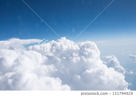 View from window of the plane above expanse of fluffy white clouds View from window of the plane above expanse of fluffy white clouds 131794929