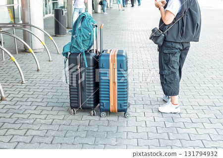 Two suitcases and backpack are on airport floor. Two suitcases and backpack are on airport floor. 131794932