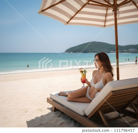 Woman in swimsuit drinking tropical juice on summer beach 131796457