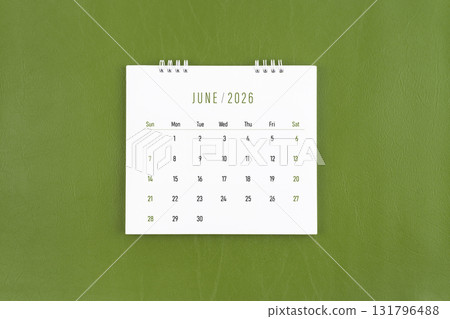 June 2026 Monthly desk calendar on green leather background. Flat lay. 131796488