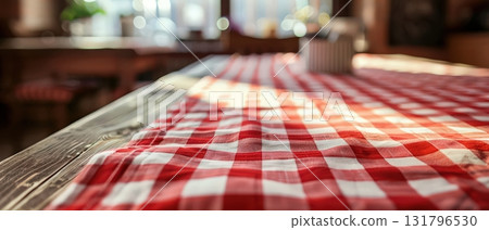 Red and white checkered tablecloth on wooden table in bright cozy kitchen 131796530