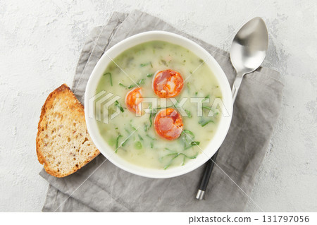 Portuguese style soup Caldo Verde with bread on gray background close up Portuguese style soup Caldo Verde with bread on gray background close up 131797056