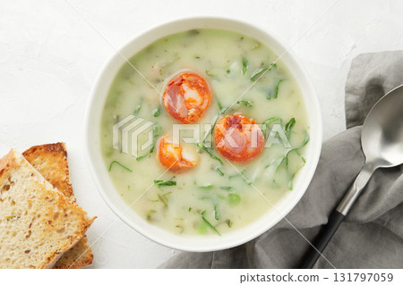 Portuguese style soup Caldo Verde with bread on gray background close up Portuguese style soup Caldo Verde with bread on gray background close up 131797059
