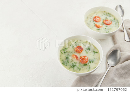 Two bowls of Portuguese style soup Caldo Verde on white background Two bowls of Portuguese style soup Caldo Verde on white background 131797062