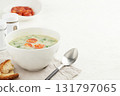 Typical Portuguese soup Caldo Verde with bread and chorizo sausage on white background 131797065
