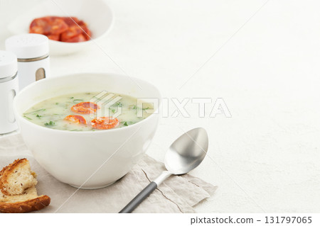 Typical Portuguese soup Caldo Verde with bread and chorizo sausage on white background Typical Portuguese soup Caldo Verde with bread and chorizo sausage on white background 131797065