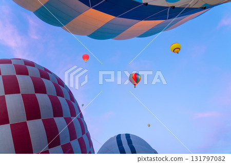 Hot air balloons ascend into the sky during a sunrise in Turkey Hot air balloons ascend into the sky during a sunrise in Turkey 131797082