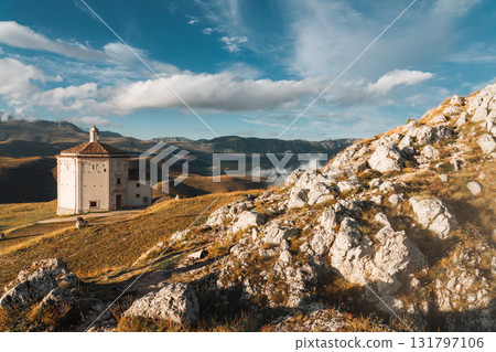 Isolated church on a mountain with village in the distance. Abruzzo, Italy 131797106